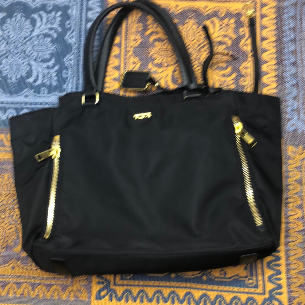 Tumi Black Tote Bag with Structured Design and Gold Accents